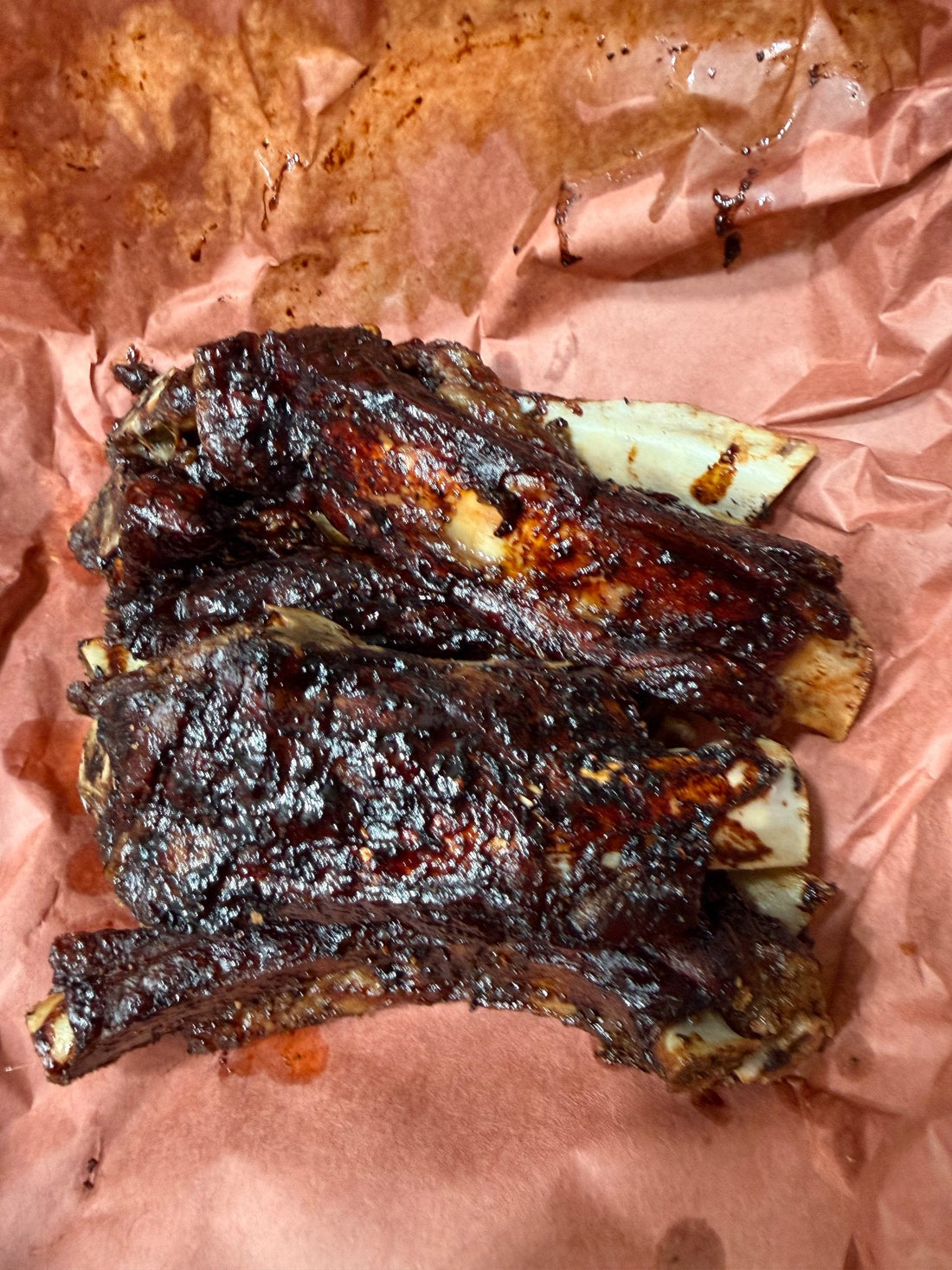 Kiawe-smoked huli huli beef ribs with Hawaiian pineapple-shoyu glaze, rested on butcher paper